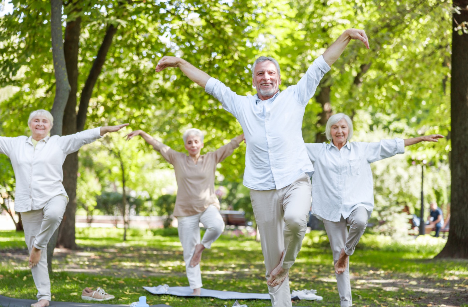 Group of seniors practicing balance exercises outdoors