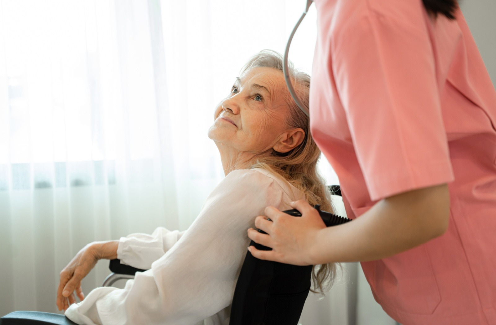 A caregiver assists a memory care resident with dementia.
